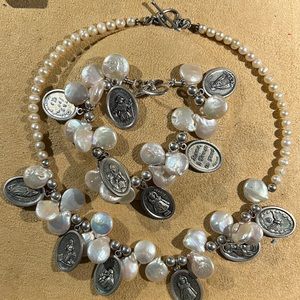 Matching necklace & bracelet featuring coin shaped pearls with silver charms